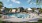 a swimming pool in front of a large building