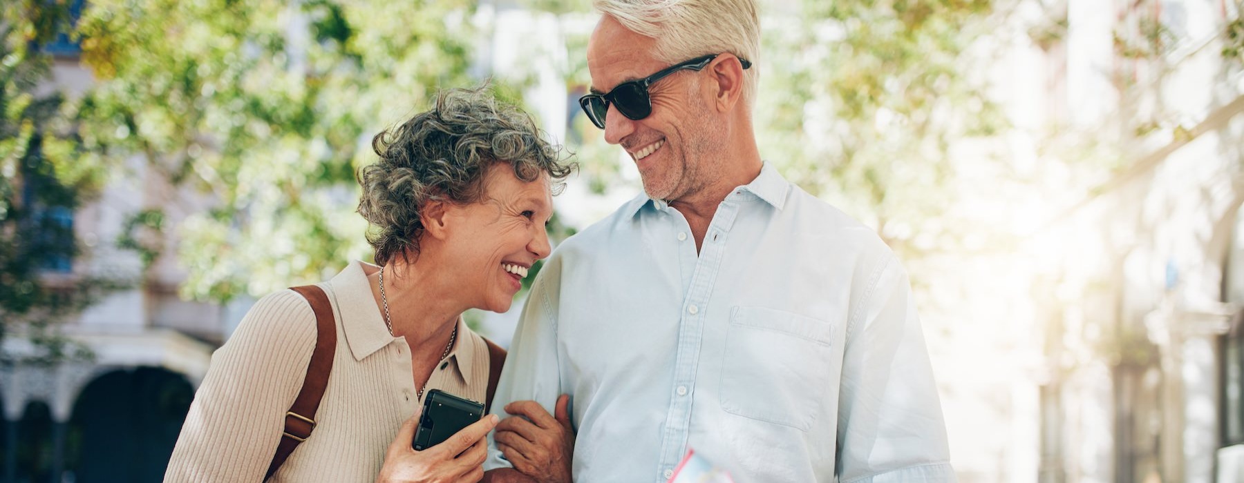 a man and a woman looking at a cell phone