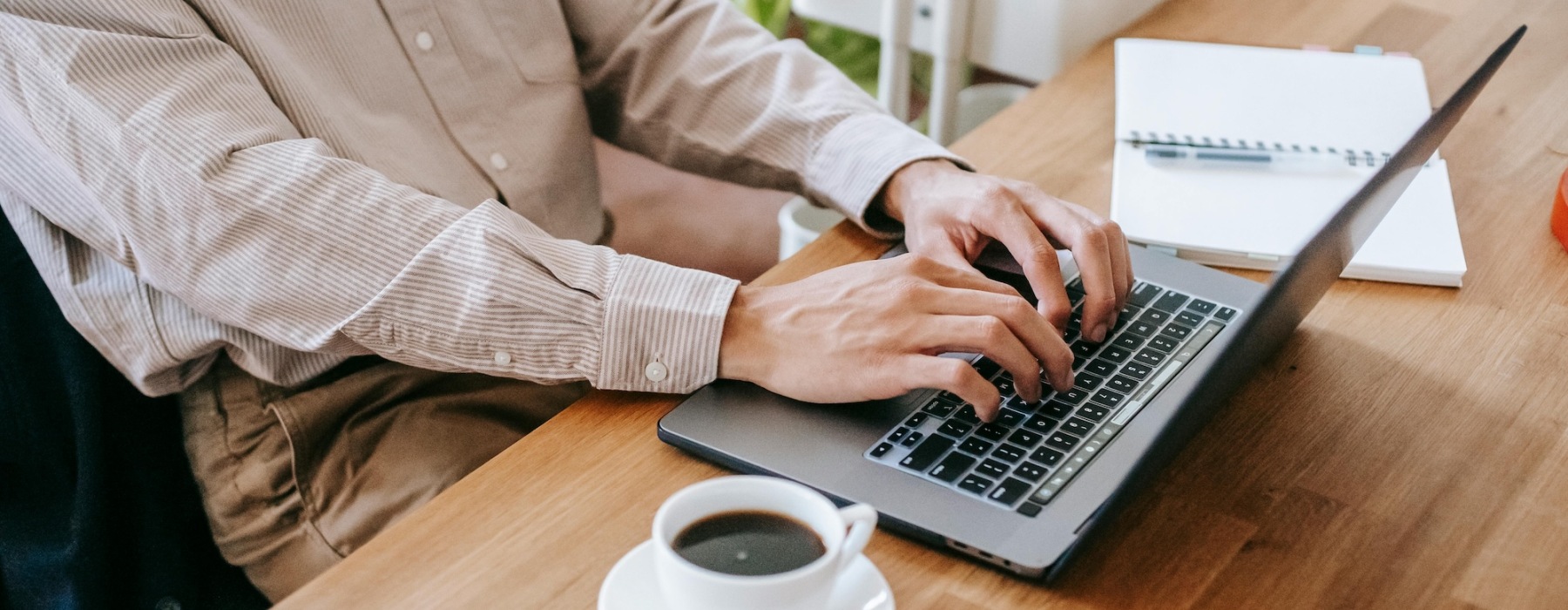 a woman typing on a laptop