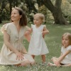 a mom and her kids in a field